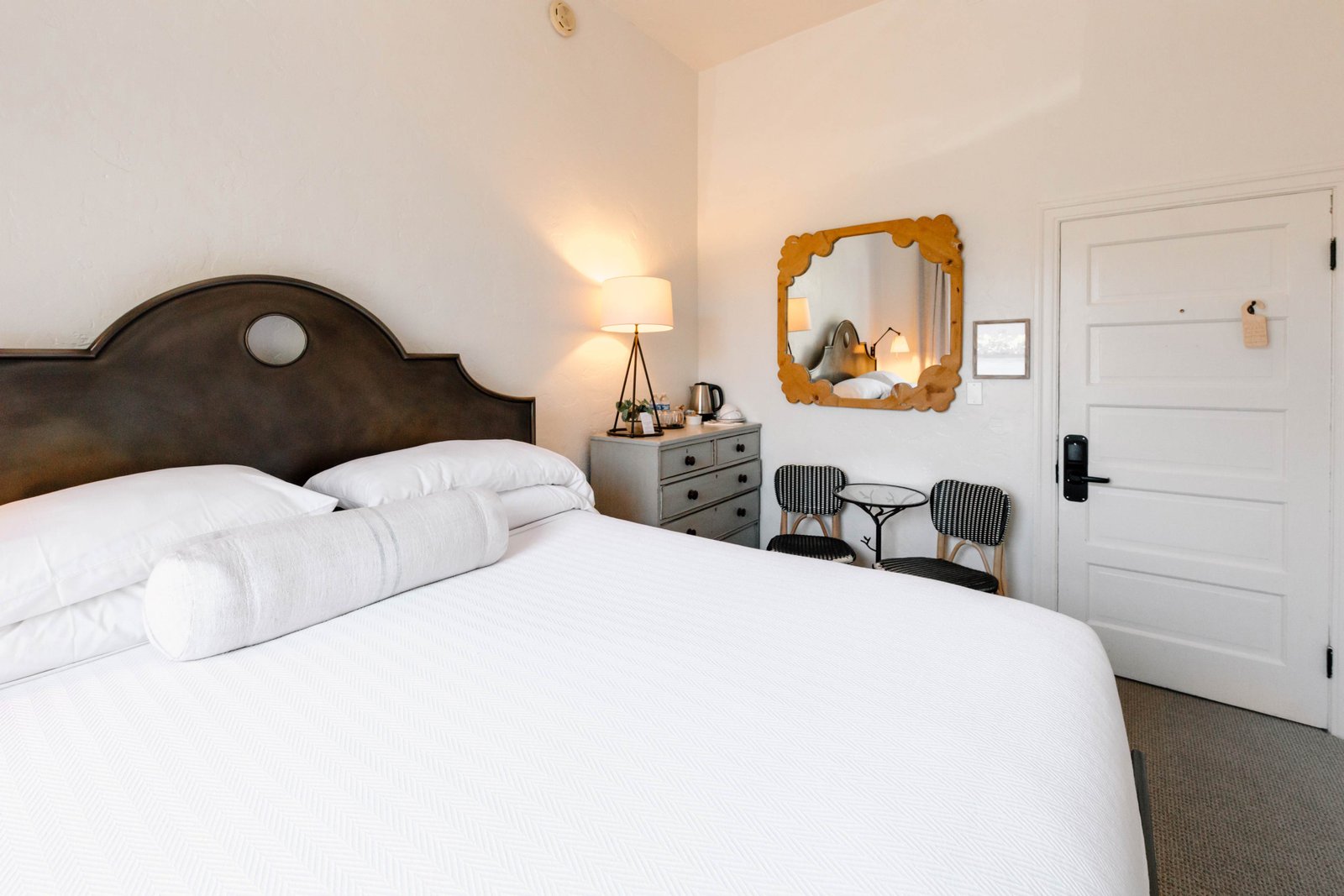 Cornflower Room 4 the interior of a room with a bed with a white comforter and a seating area